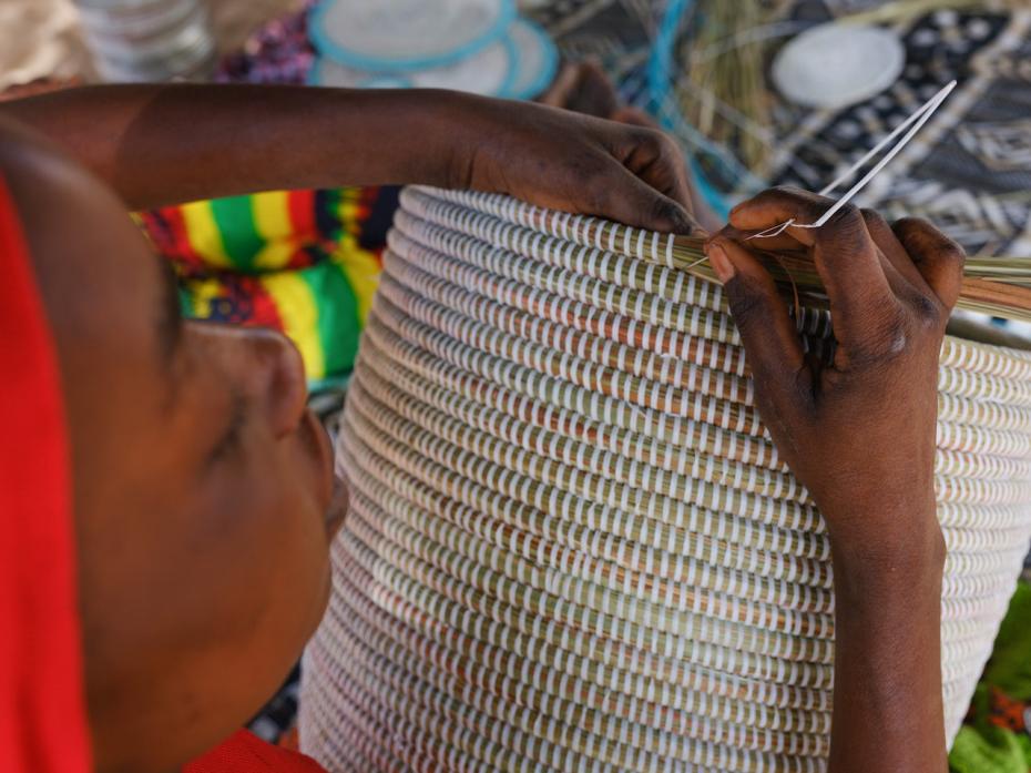 Artisanne weaver weaving an Artisanne basket